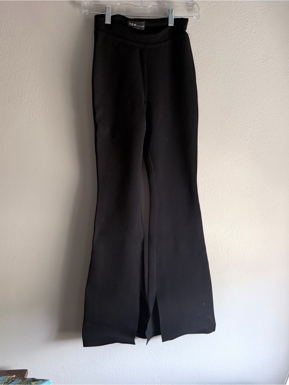 Aritzia Ten by Babaton Black wide leg pants with a slit in the front.